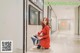 a woman in a red dress sitting on the floor