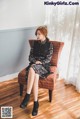 A woman sitting on a chair in a room.