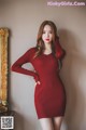 a woman in a red dress posing for a picture