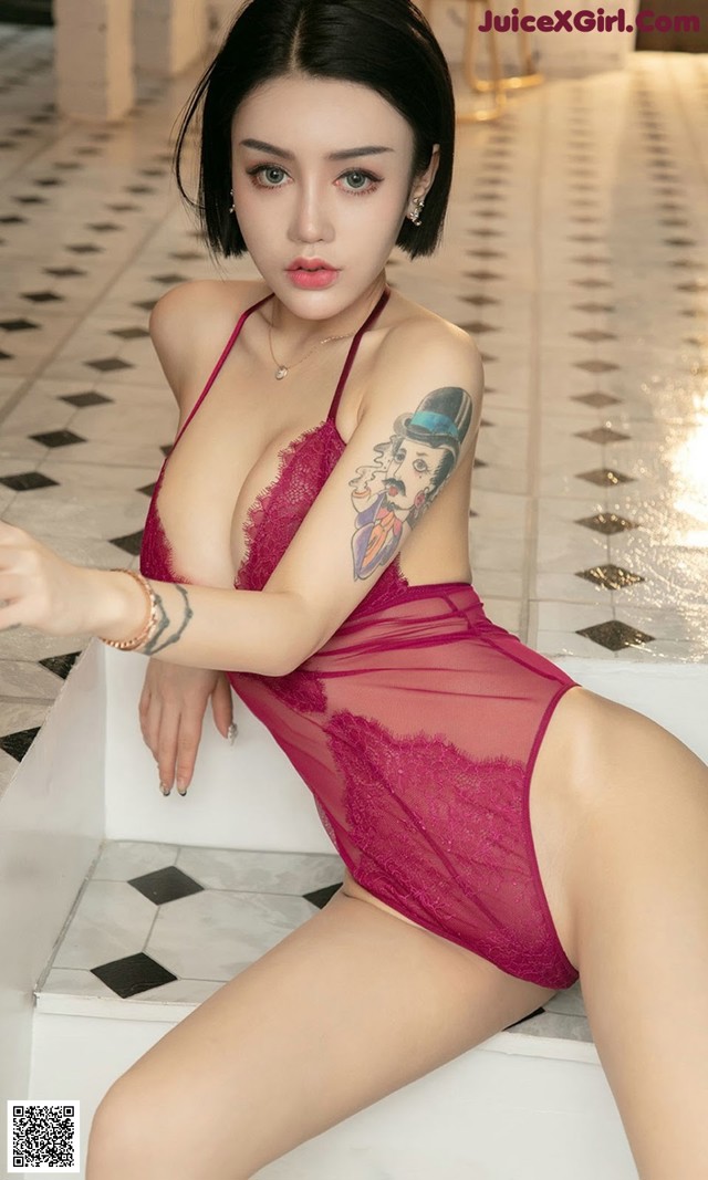 A woman in a red lingerie sitting on a white bench.