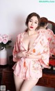 a woman in a pink kimono posing for the camera