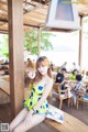 A woman sitting on a wooden bench in a restaurant.