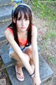 A young woman sitting on the steps of a building.