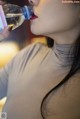 A woman drinking water from a bottle. 