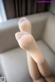 A close up of a person's feet on a chair.