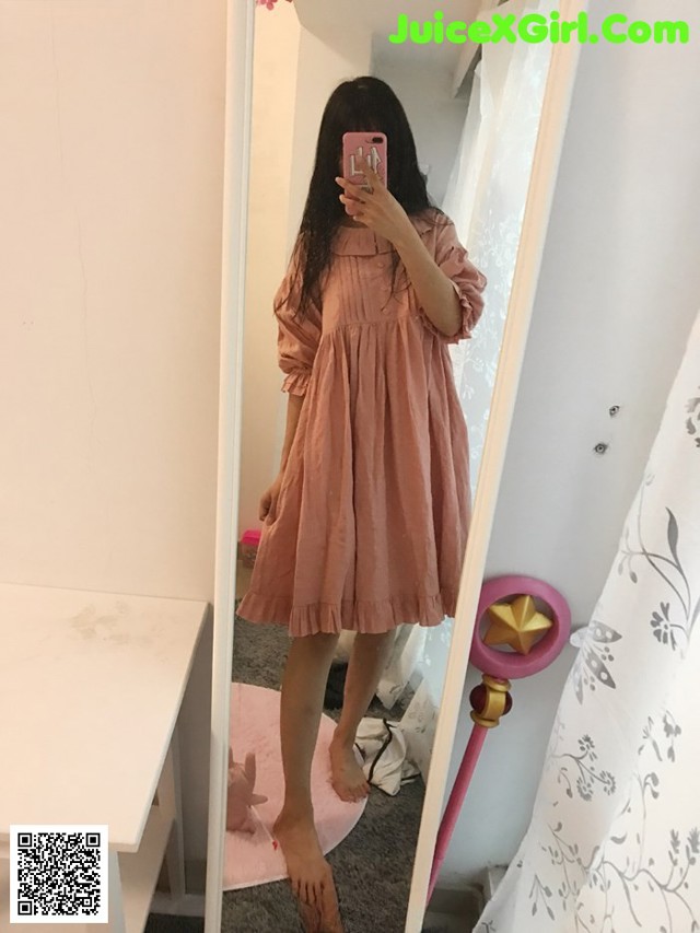 A woman taking a selfie in a mirror.