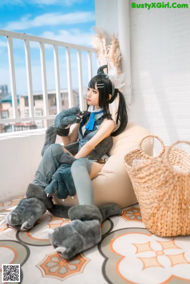 A woman sitting on a bean bag chair with a stuffed animal.
