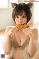 A woman in a furry outfit eating a piece of bread.